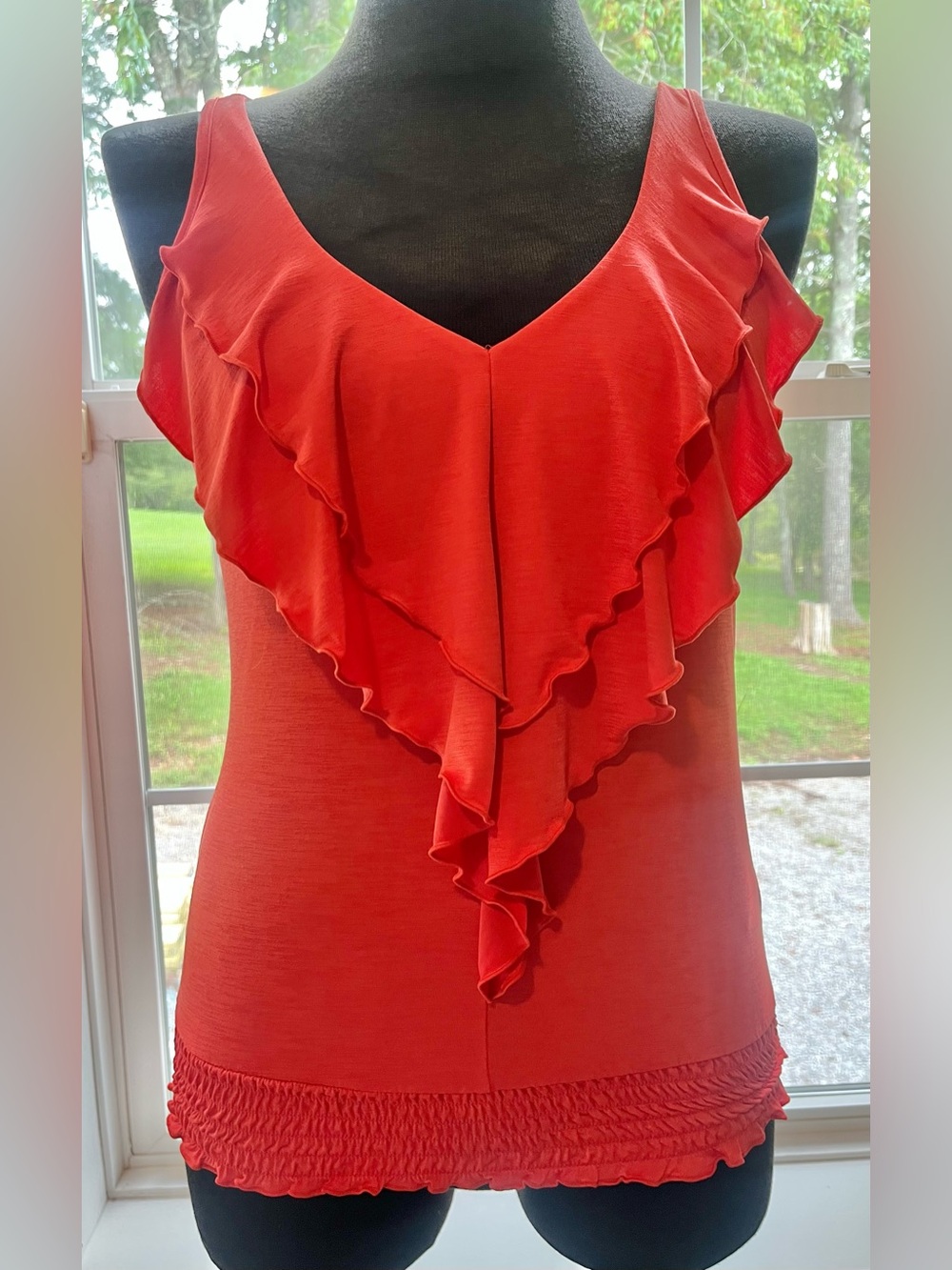 Vibrant coral Heart Soul tank top features a striking ruffle front design
